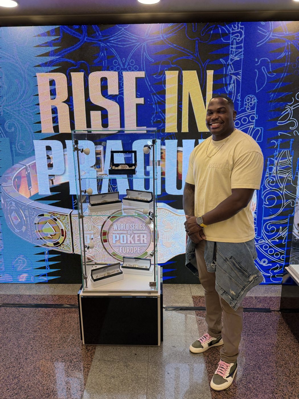 Nicholas Smith beside the World Series of Poker Europe bracelet display in Prague