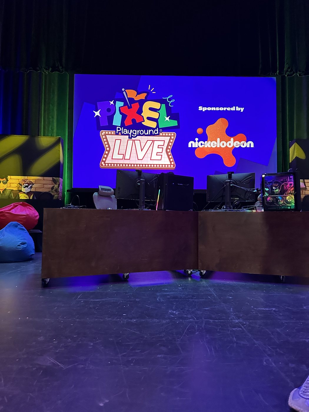 Pixel Playground Live stage with gaming stations and a Nickelodeon sponsor screen