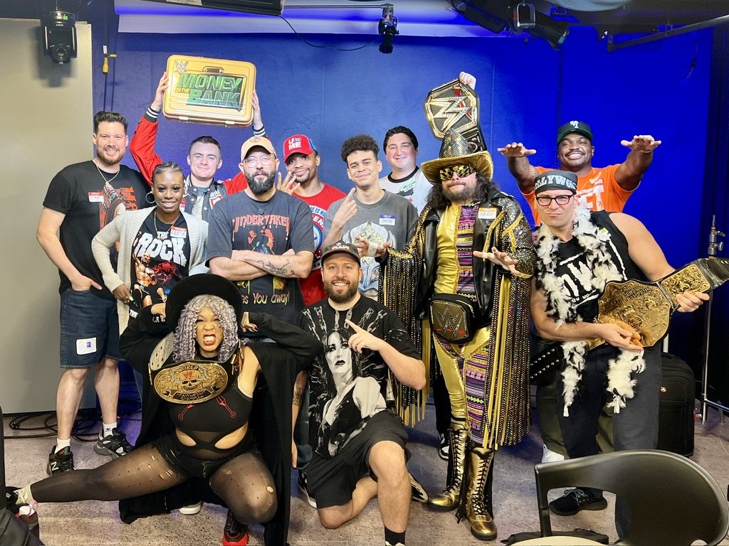 Cast and crew of a wrestling-themed House of Highlights episode with championship belts